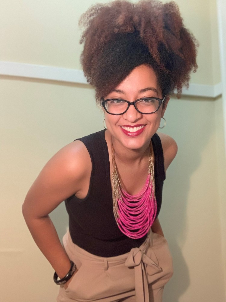 Picture of a woman standing with hands in pocket