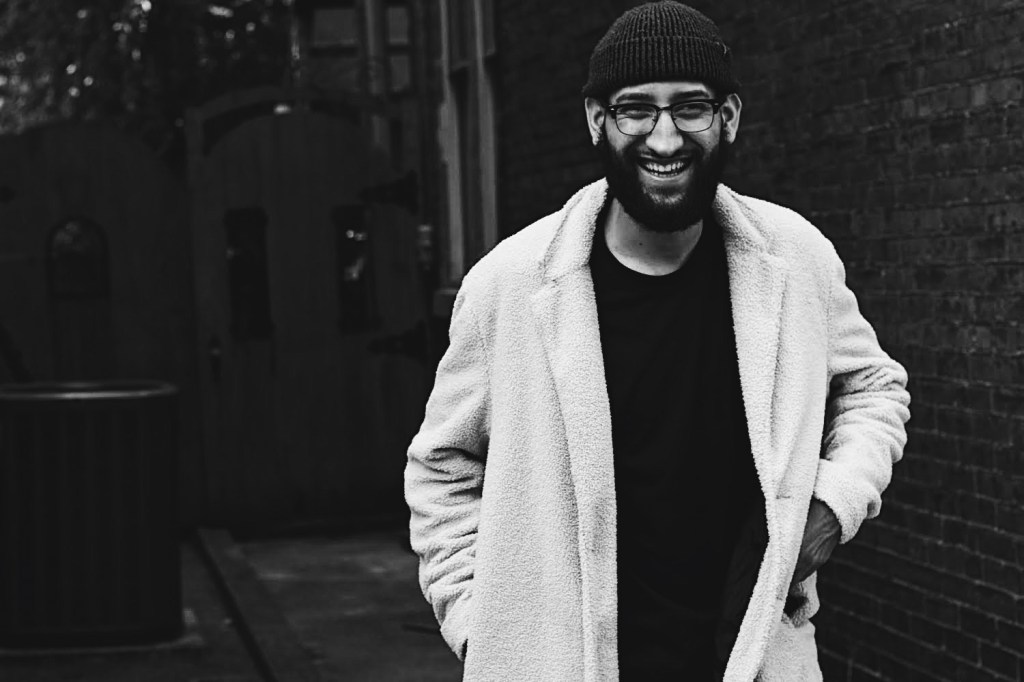 Man smiling while standing outside