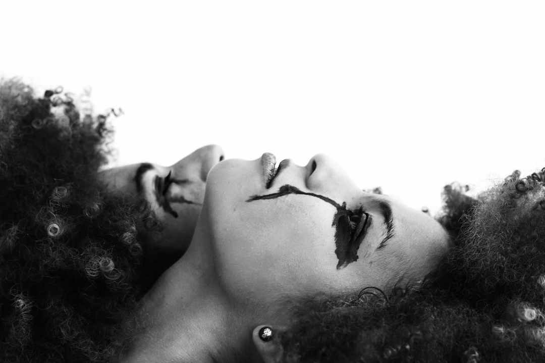 grayscale photo of two Black women with makeup running down their faces