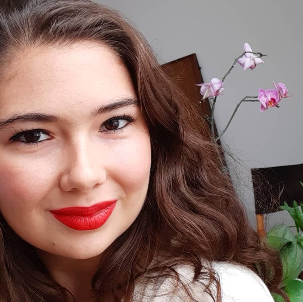 Profile of woman with orchids in the background